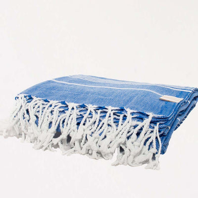 Blue Turkish towel with white trim folded